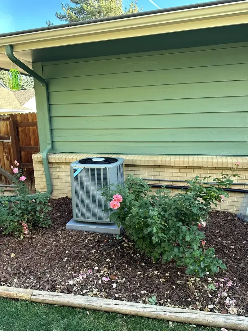 New Daikin air conditioner condenser on a pad at a Denver metro home