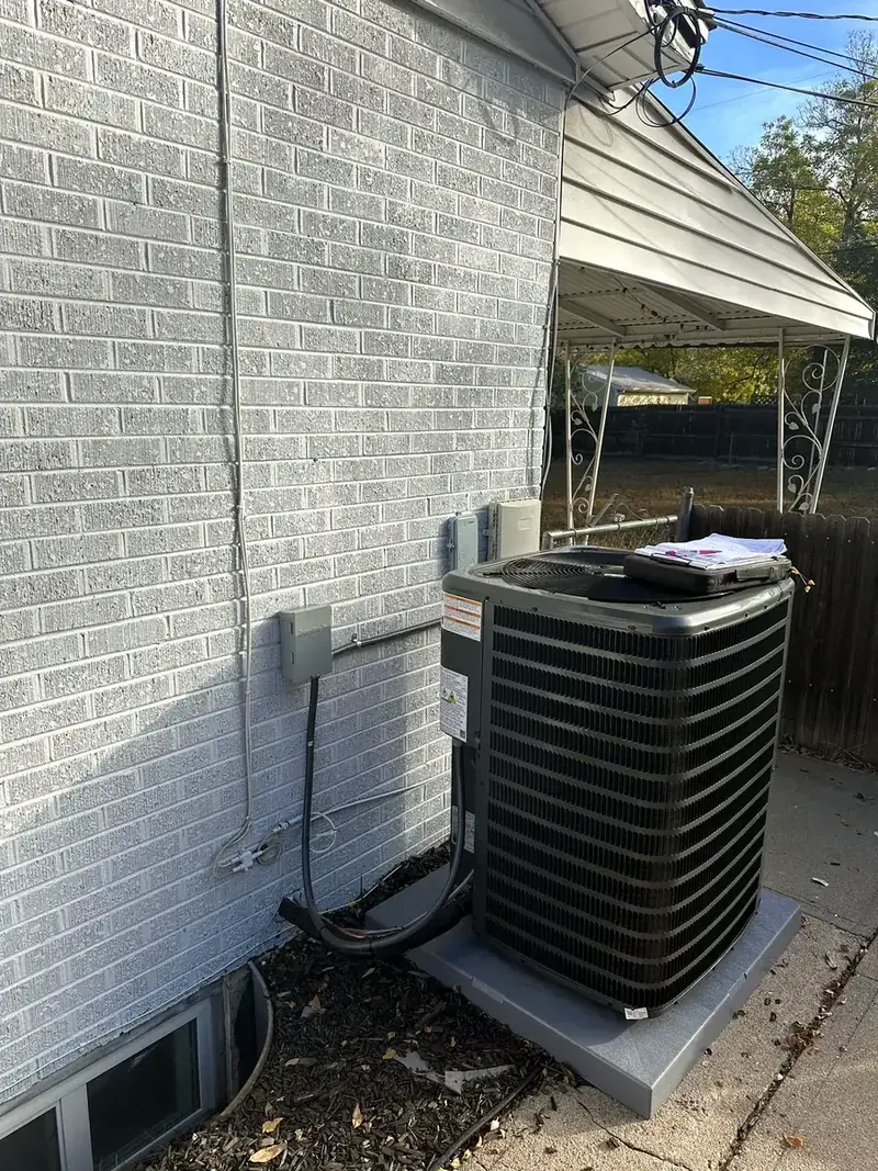 New Goodman air conditioner condenser on a pad at a Denver metro home